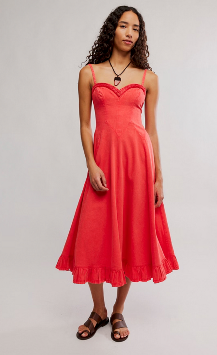 Woman wearing a sour sweet dress on a plain background