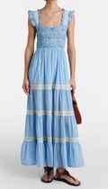 Woman wearing a blue dress with white stripes on a white background