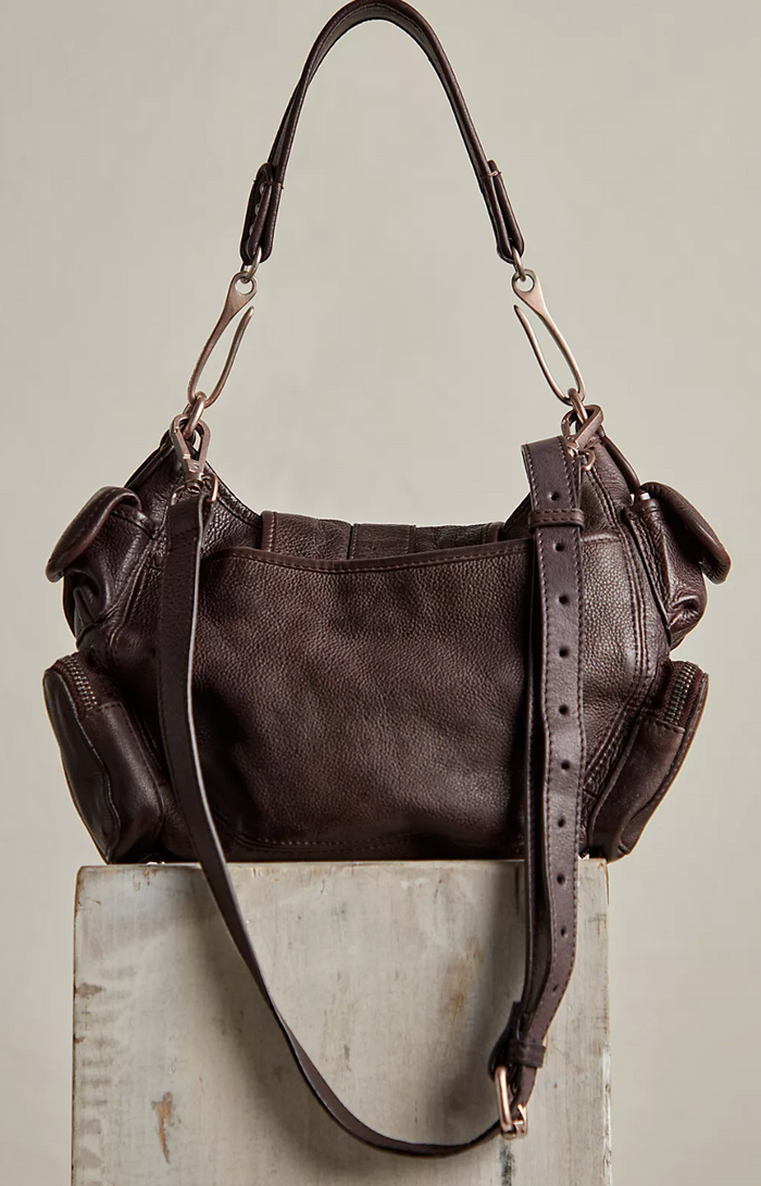 Brown leather handbag on a light gray background