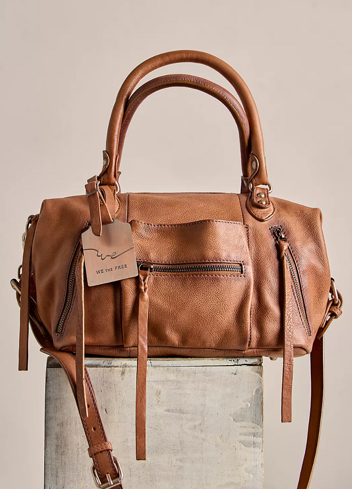 Free People leather handbag in saddle with a visible brand tag on a neutral background