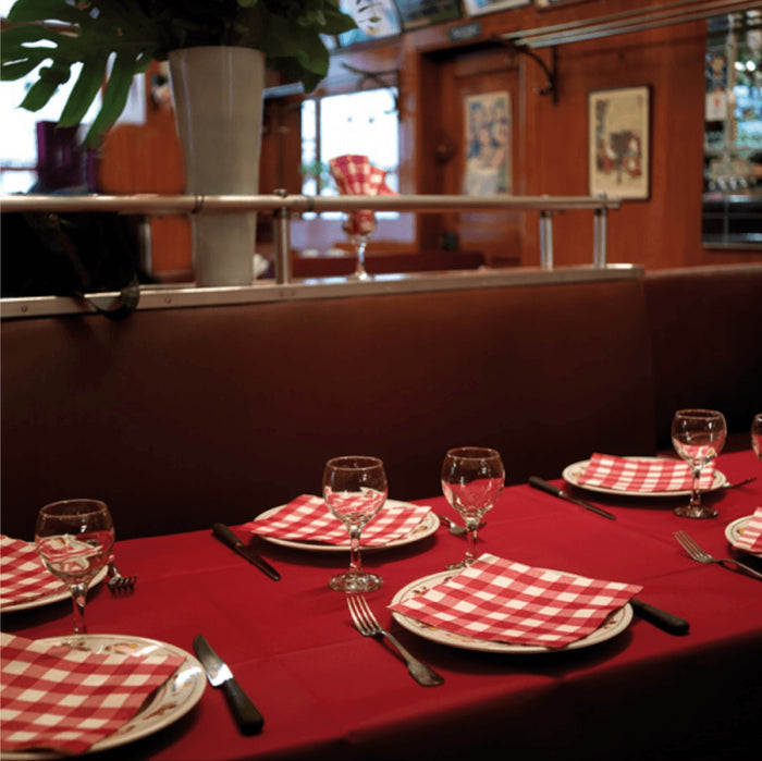 Eclectic Françoise Paviot Bistrot Rouge red and white gingham dinner napkins set on a restaurant table