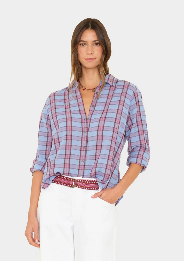 Woman wearing a plaid shirt with a white background