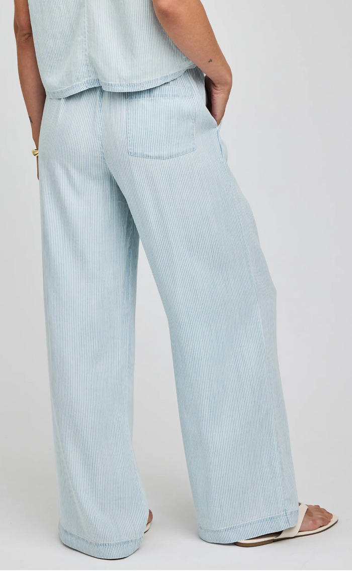 Light blue striped pants worn by a person on a white background