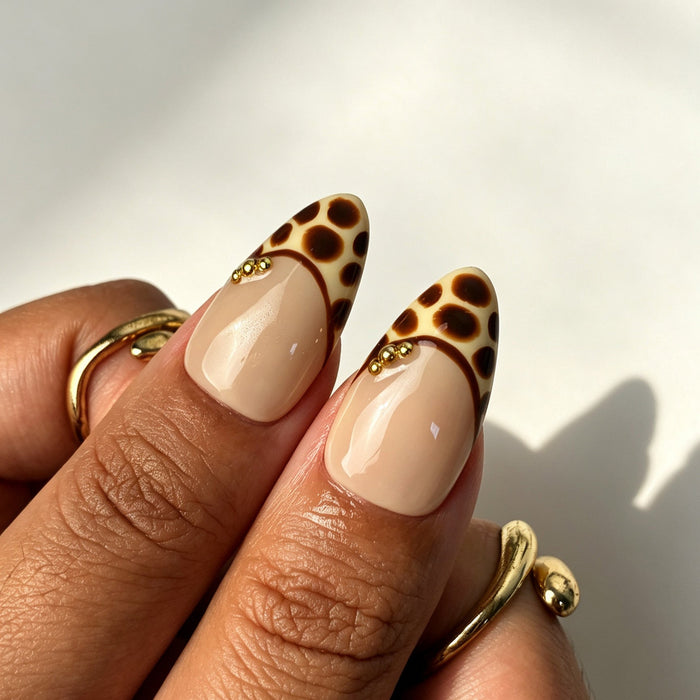 Soft vintage almond press on nails, nude base, caramel leopard French tip, 3D white flower, gold bead and brown swirl