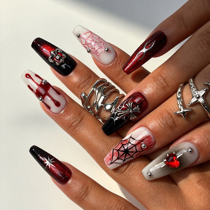 Hand wearing Crimson Star long gothic coffin press on nails, dark goth halloween false nails