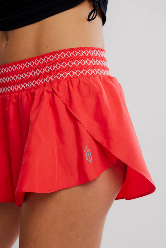 Free People Element Electric Sunset short with white embroidery on a plain background