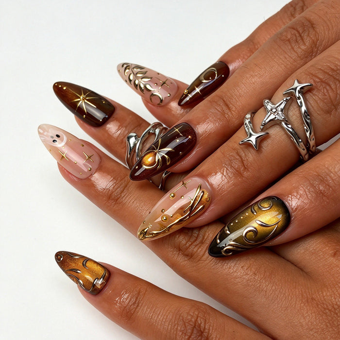 Hand model wearing Ember Mystic almond press on nails, amber gold mystic Halloween nail art