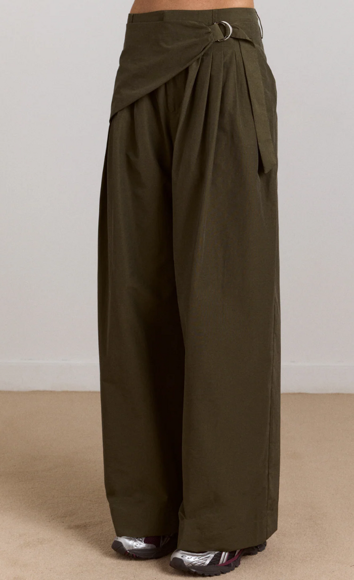 Khaki wide-leg pants with a belt on a beige background
