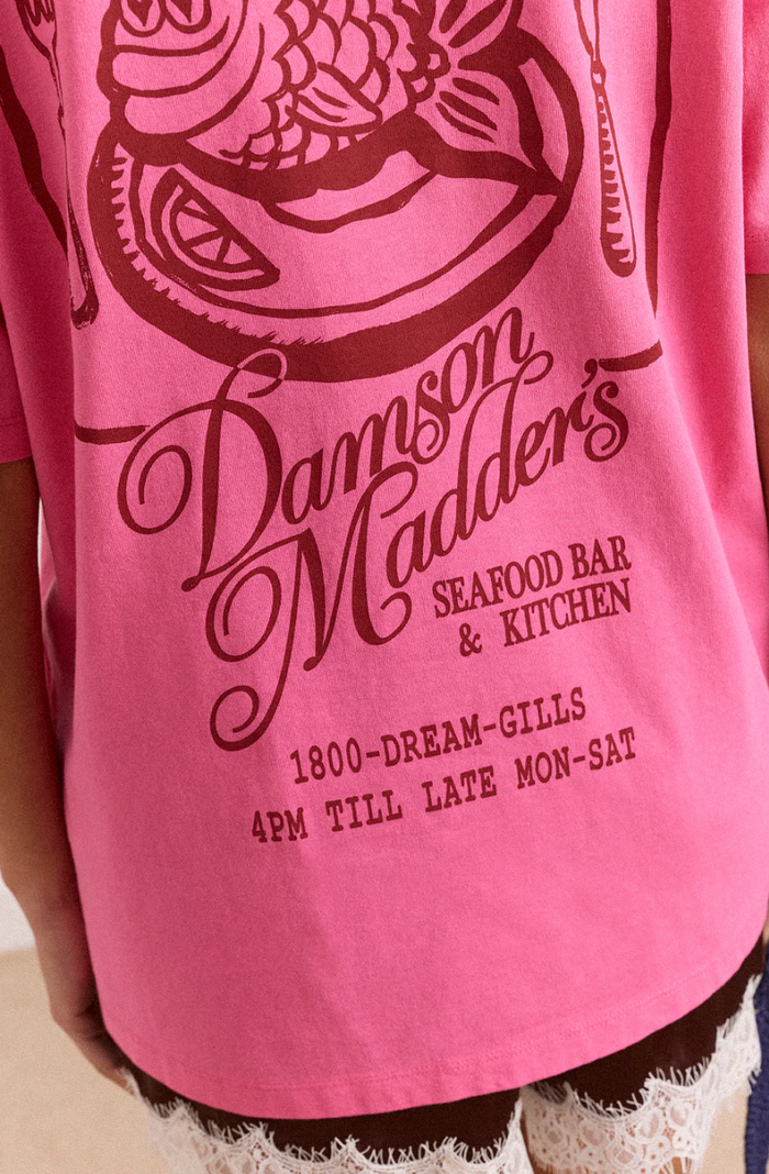 Pink t-shirt with 'Damson Madder's Seafood Bar & Kitchen' text and graphics.