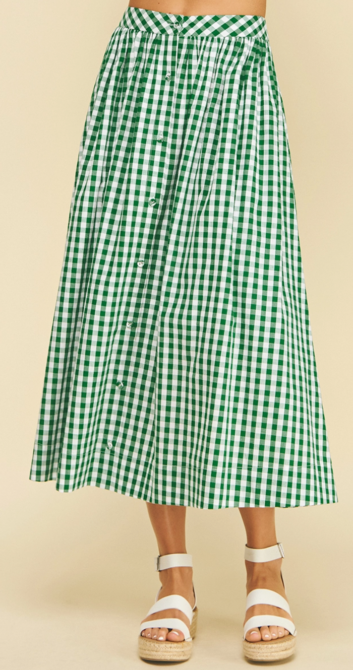 Green and white checkered skirt worn by a person on a beige background