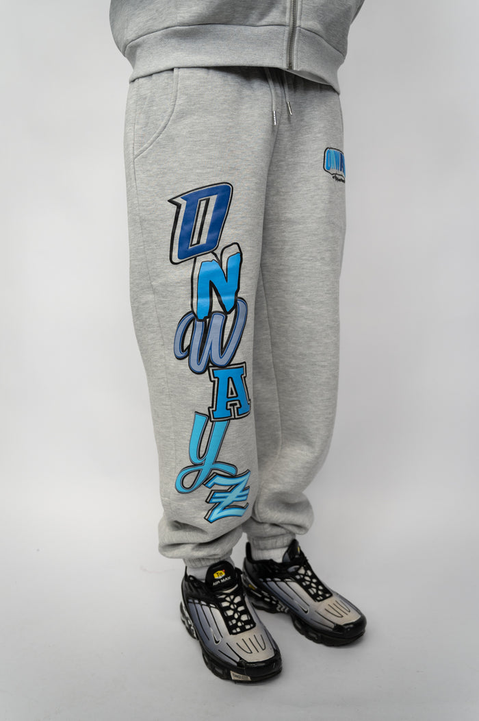 Gray sweatpants with blue text and graphics on a gray background