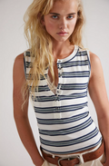 Woman wearing a striped sleeveless shirt against a plain background