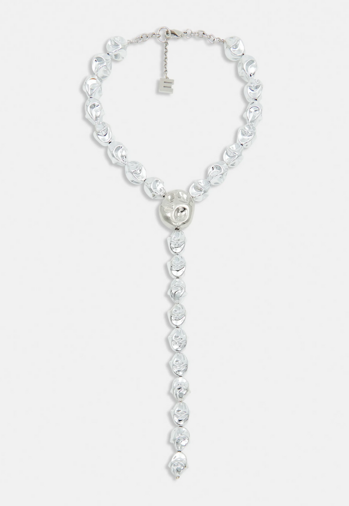 Silver necklace with heart pendant on a white background