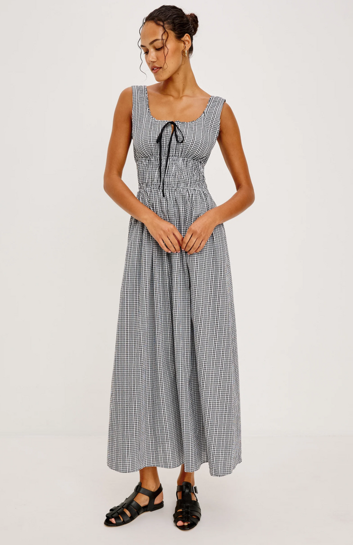 Woman wearing a checkered dress on a white background