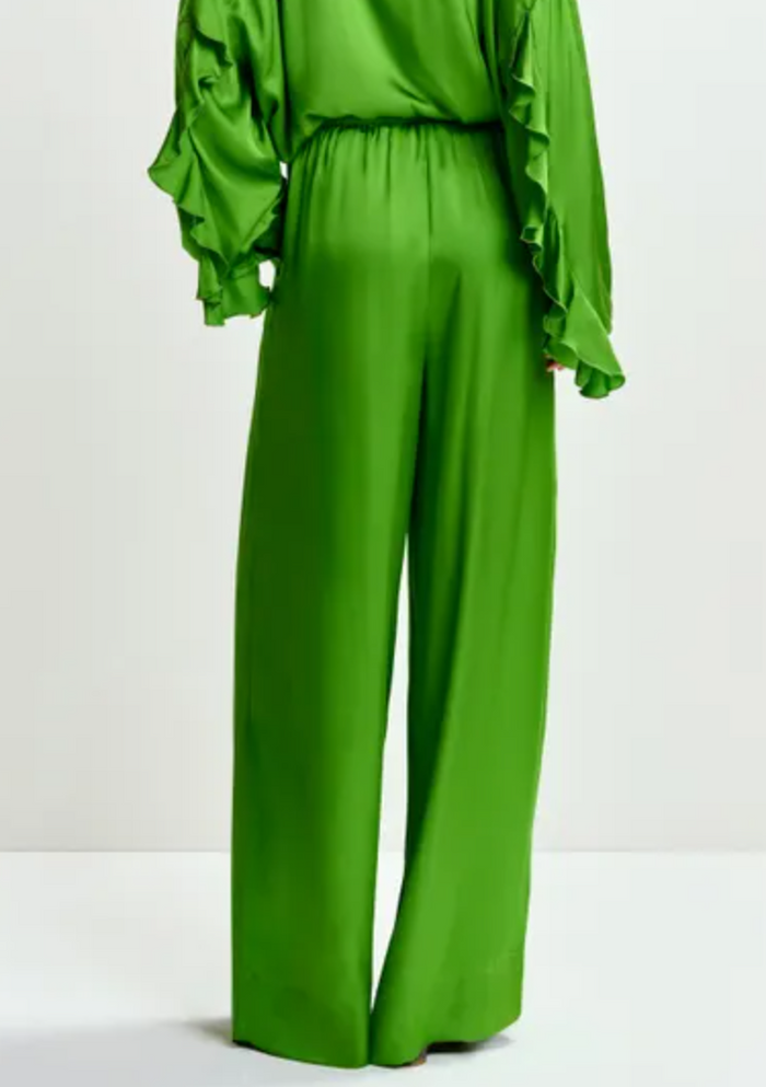 Green satin outfit with ruffled sleeves on a white background