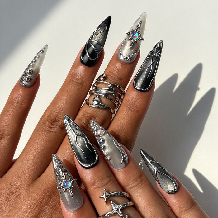 Close-up shot of Lunar Shard silver black chrome opal star handmade stiletto press on nails
