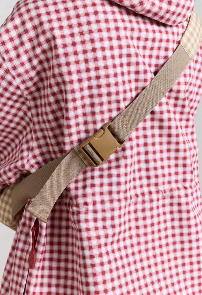 Red and white checkered shirt with a brown strap over a gray background