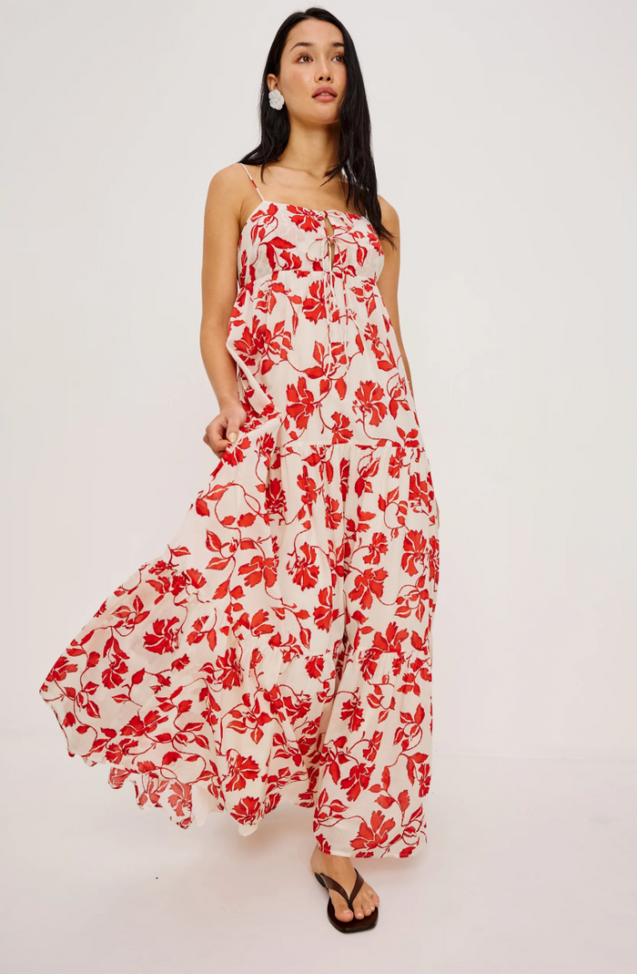 Woman wearing a red floral dress on a white background