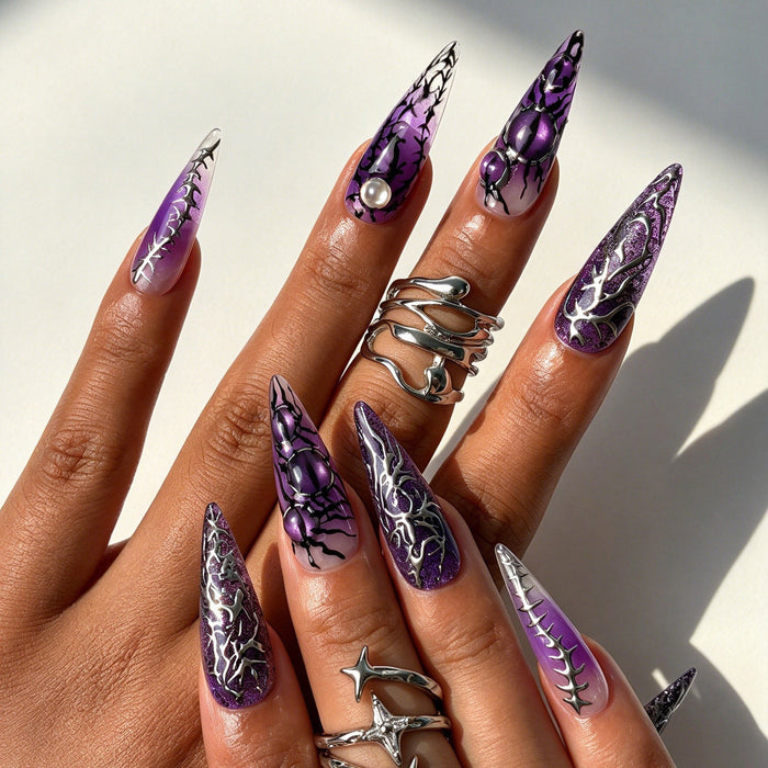 Close-up shot of Noir Arachnid purple gradient silver spider charm handmade stiletto press on nails