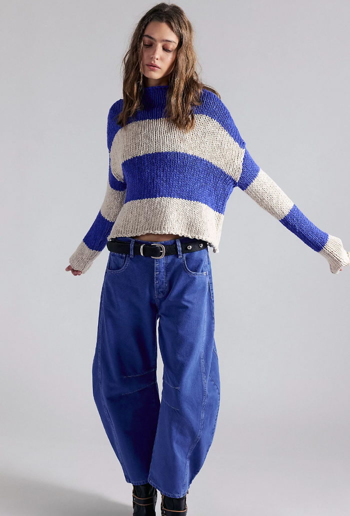 woman wearing Free People Opal Stripe in Cobalt with jeans against white background