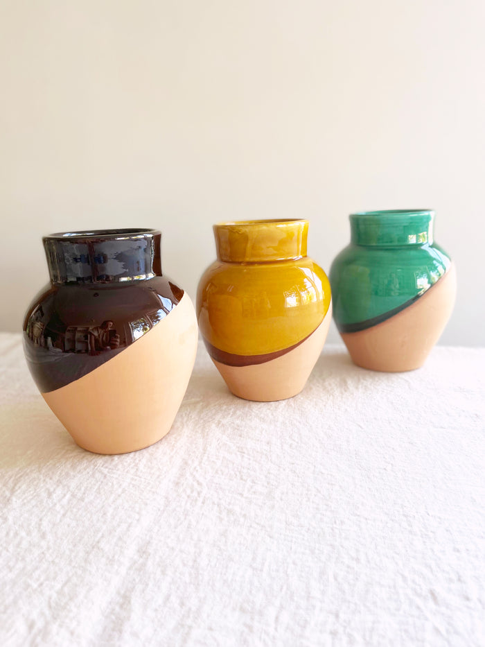 green black and cream pottery vase in group of three on table