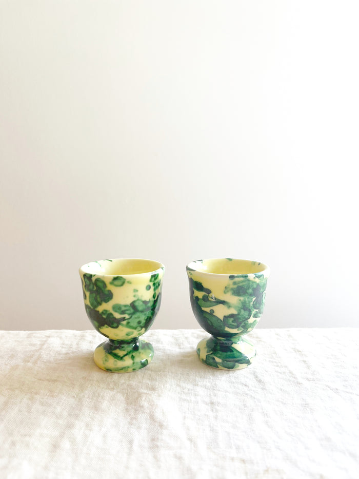 cream egg cups with green splatter pattern 2 inches in diameter