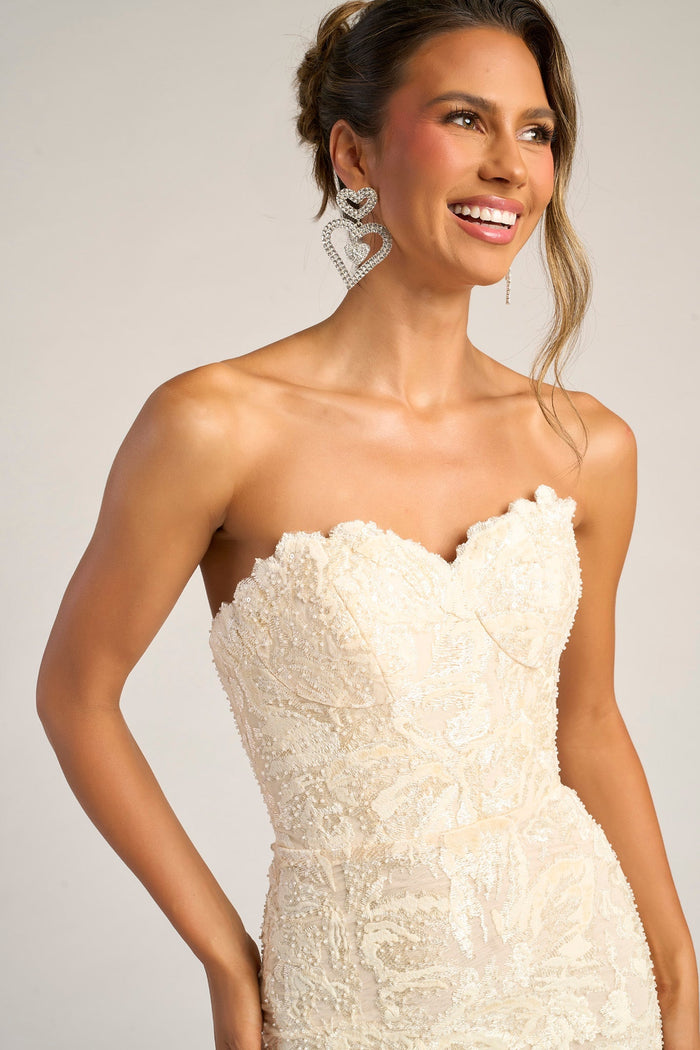 Cream strapless gown with heart earrings