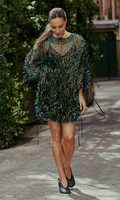 Woman walking outdoors wearing a patterned dress.
