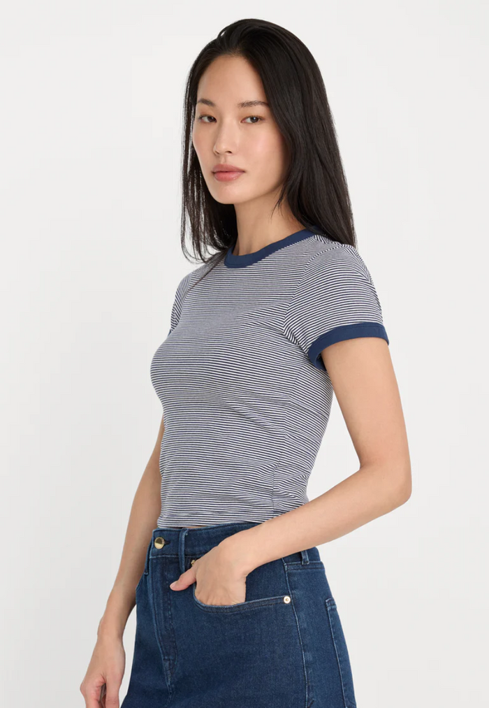 Woman wearing a striped shirt and jeans on a white background