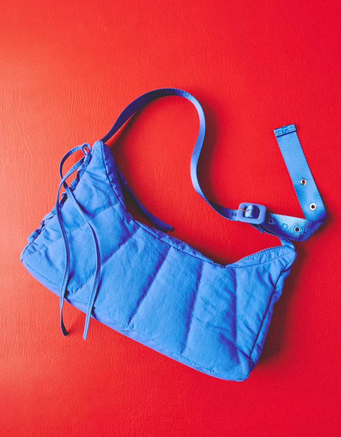 Damson Madder saw bag in cobalt on a red background