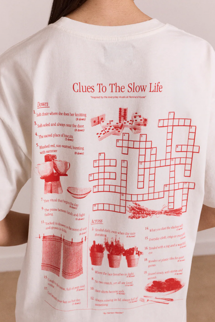 White t-shirt with red graphic and text on a plain background