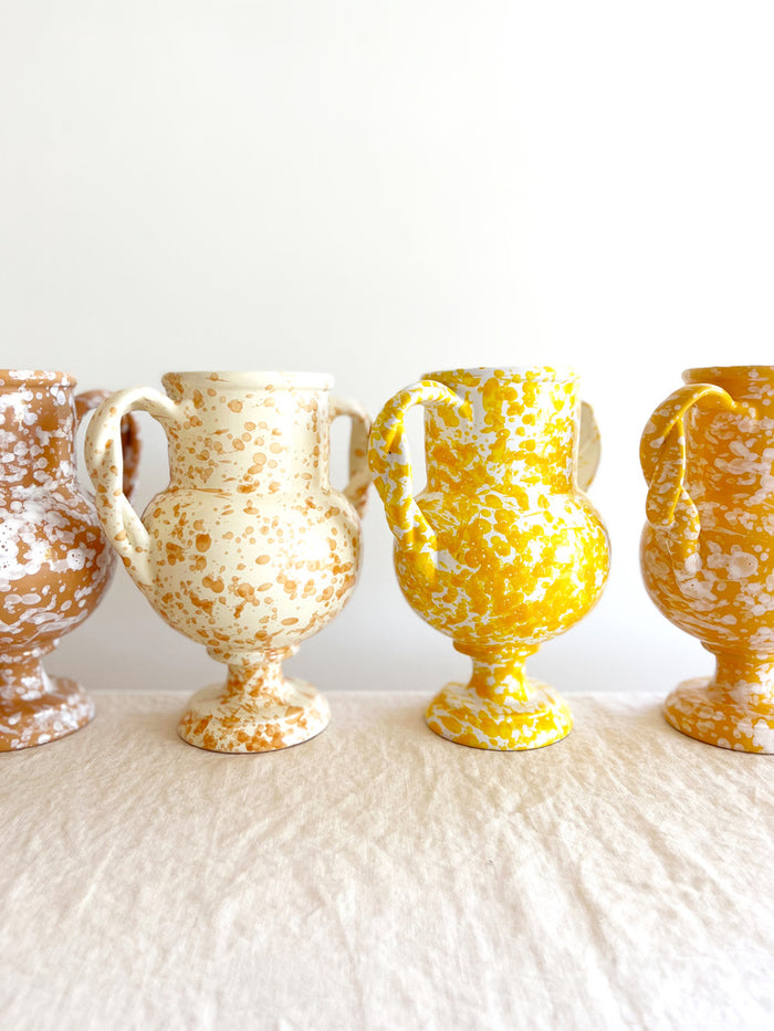 small white amphora vase with yellow speckle pattern 8.25 inches tall in group of four