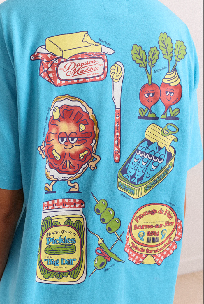 Colorful graphic t-shirt with various illustrations on a blue background