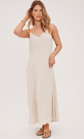 Woman wearing a beige linen dress on a white background