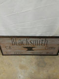 wooden framed blacksmiths sign