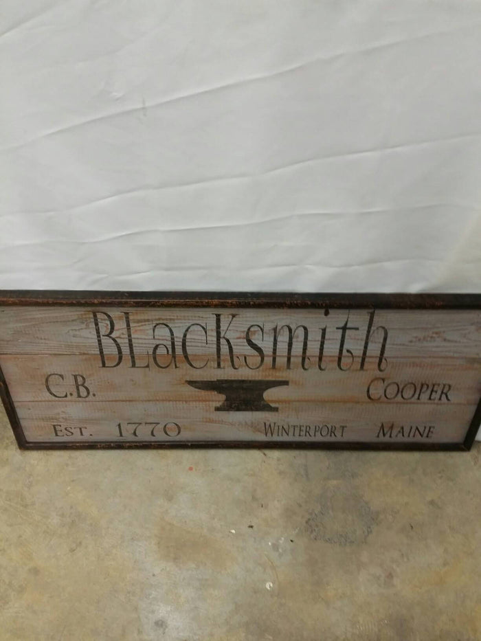 wooden framed blacksmiths sign